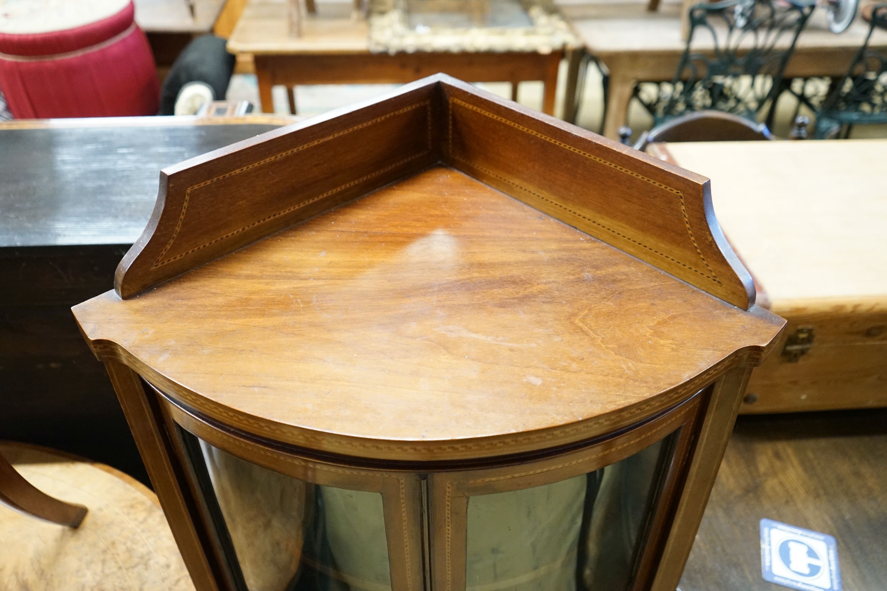 An Edwardian inlaid mahogany bow fronted standing corner cupboard, width 60cm, depth 44cm, height 130cm